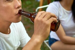 man drinking beer outdoors FZU6AGX scaled 1